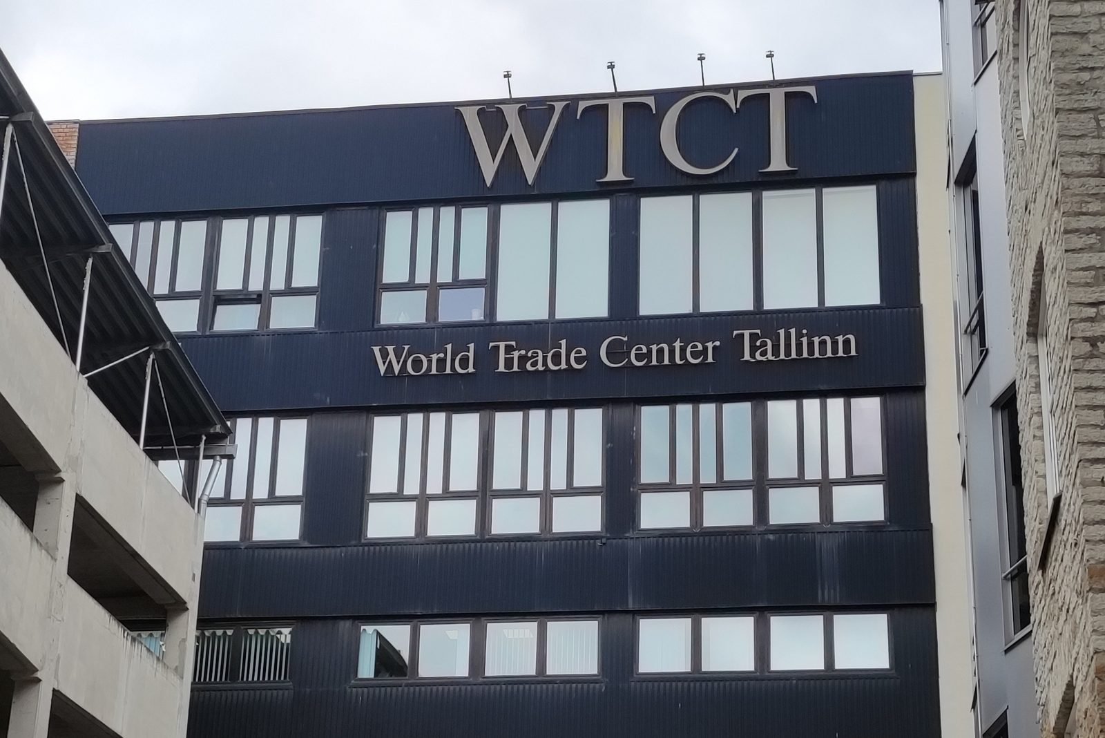 The dark facade of the World Trade Centre Tallinn, with the letters WTCT and the words World Trade Center Tallinn in gold above the upper floors